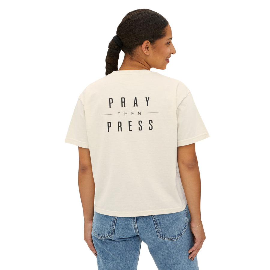 Person wearing a white t-shirt with a pizza design and text on the back, standing against a white background.