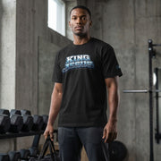 Man wearing a black t-shirt with 'King Jesus' text in a gym setting